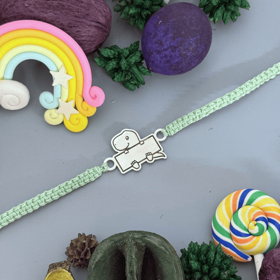 tiny dino rakhi_925 silver rakhis_rakhis for raksha bandhan_initial letter rakhis_gifts_raksha bandhan_special rakhis_brother sister gifts 925 SILVER TINY DINO NAME RAKHI - Image 1